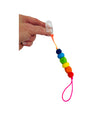 a hand holding the rainbow Chewy Charms Chewy Loop Shirt Saver - Clip On