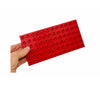 a hand holding the red Coko Bricks Base Plate - Small