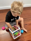 a young boy playing with the Fat Brain InnyBin