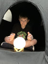 a young boy sitting in the Pokano Dark Den with a sensory light