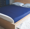 Navy coloured Harkla Sensory Compression Sheet - Queen on double bed with white pillows and wooden bed frame